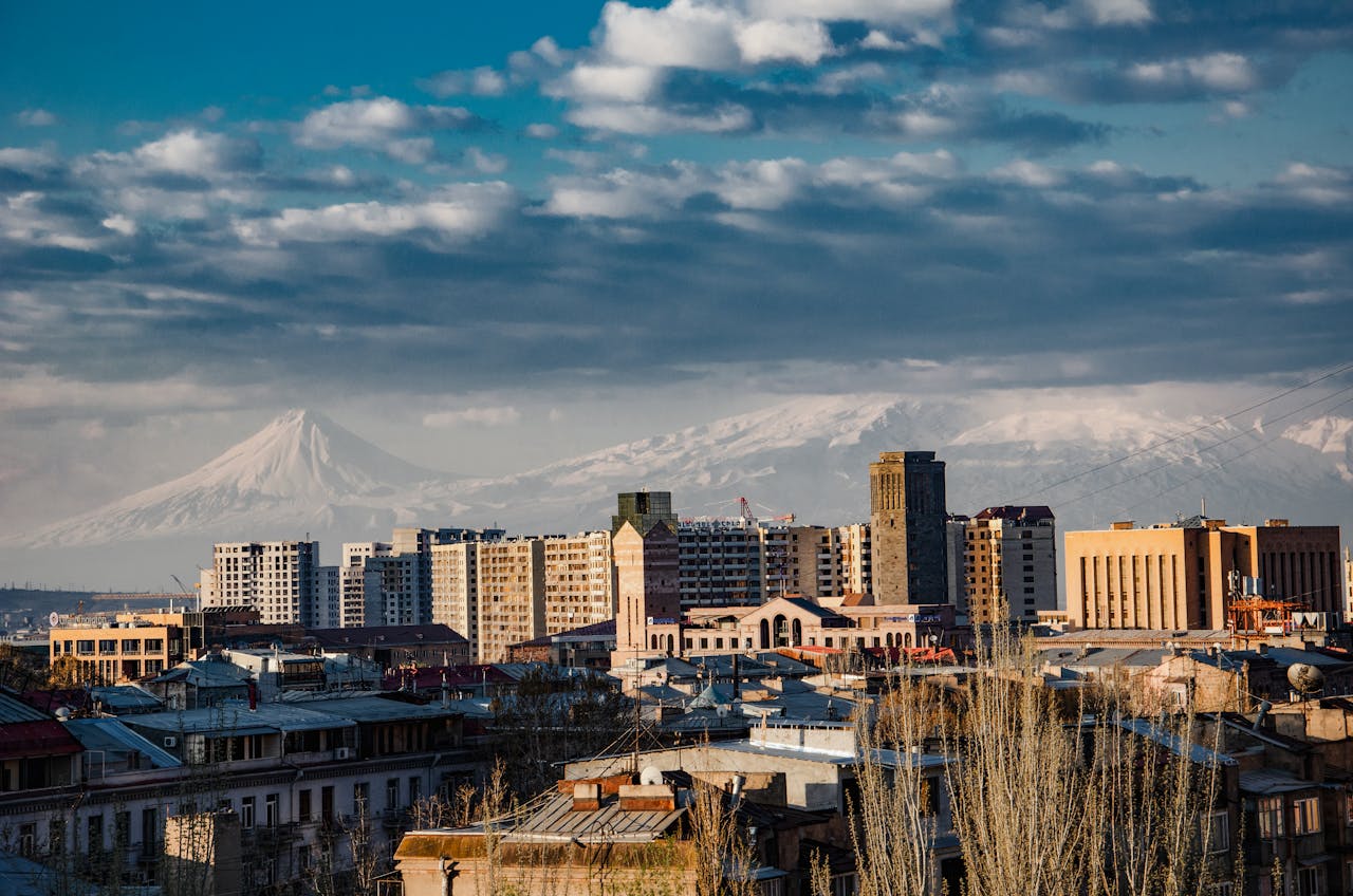 City skyline with snowcapped mountains. Perfect blend of urban architecture and natural beauty.